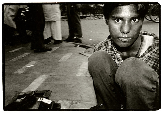 author: Stefan Rohner
title: 	Varanasi, young boy with his shoe polishing box.